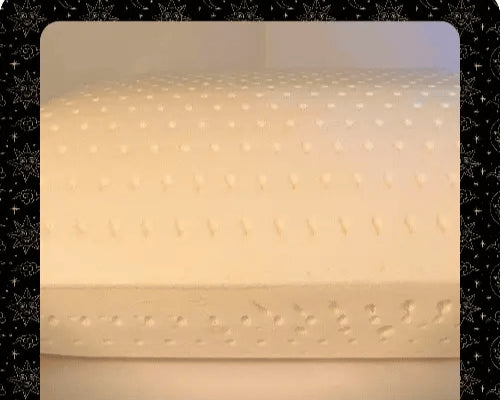 Talalay latex pillow with decorative stitching on a plain background