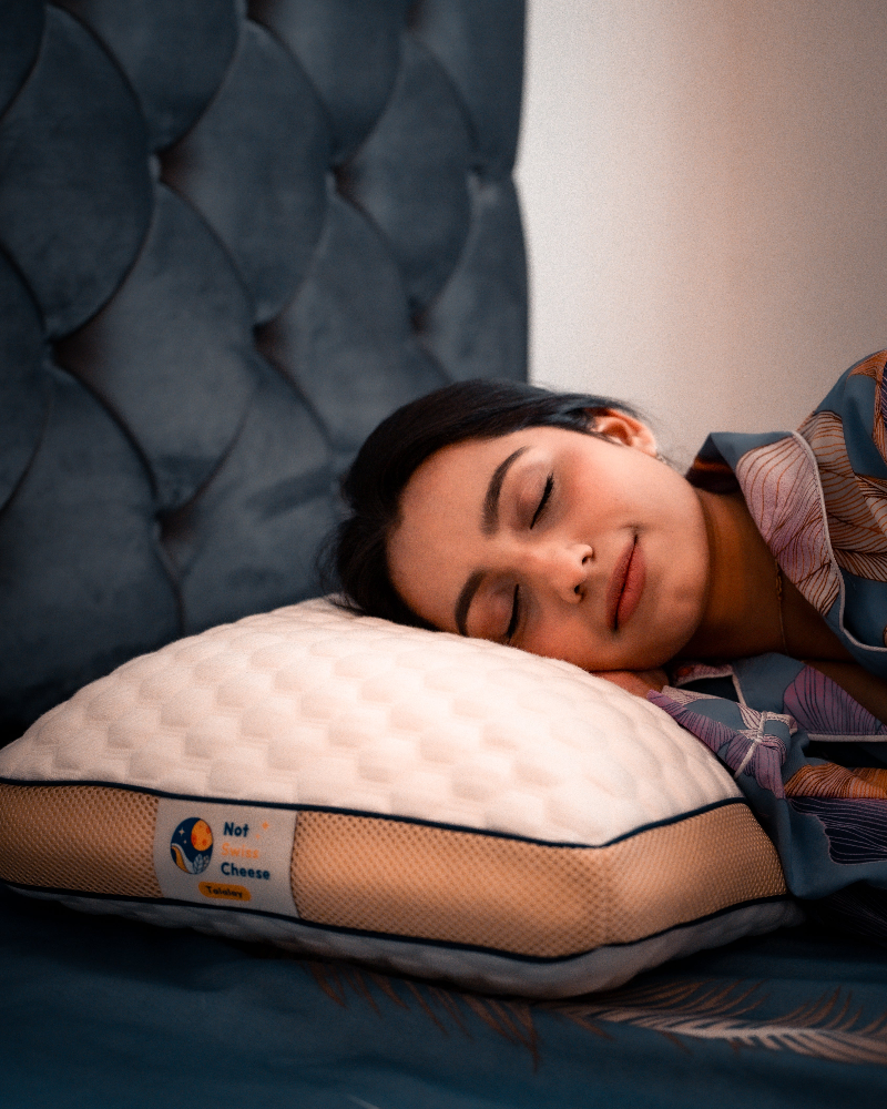 Young woman sleeping on Not Swiss Cheese Talalay latex pillow - best pillow for side sleepers with neck pain